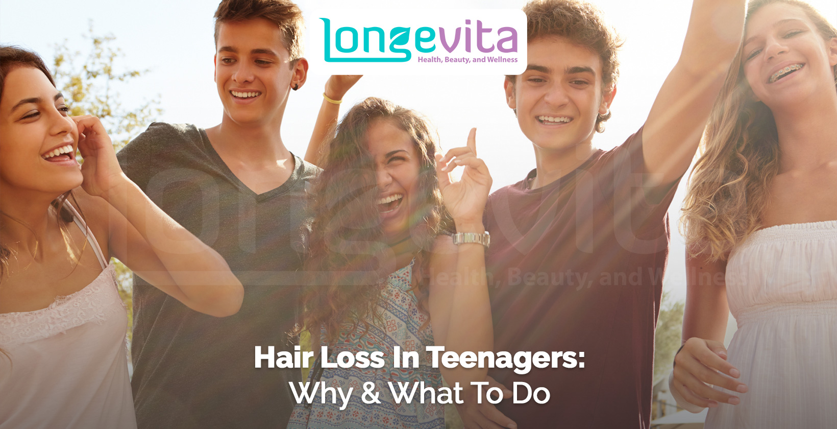 group of smiling teenagers outdoors raising their hands in joy