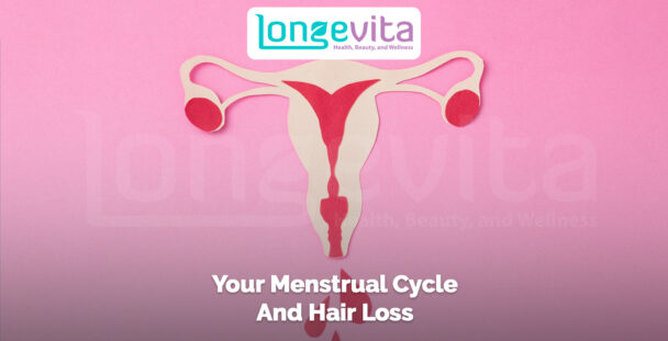 anatomical paper cutout of female reproductive system on a pink background