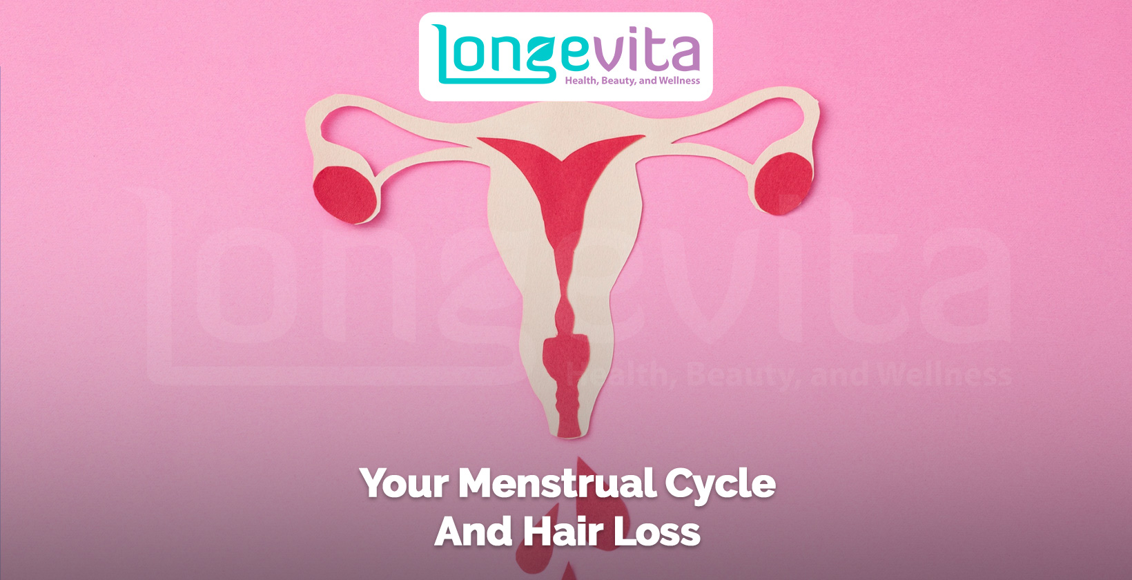 anatomical paper cutout of female reproductive system on a pink background