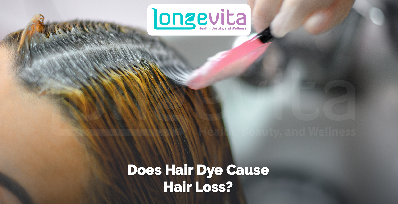 close-up of hair dye being applied to roots with a brush