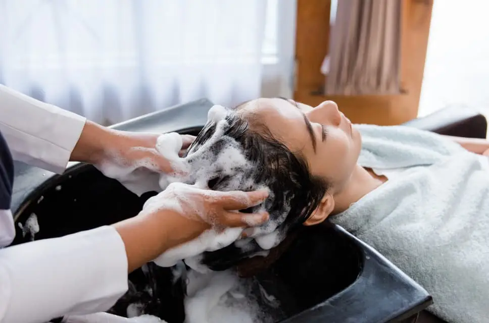 woman getting hair shampooed