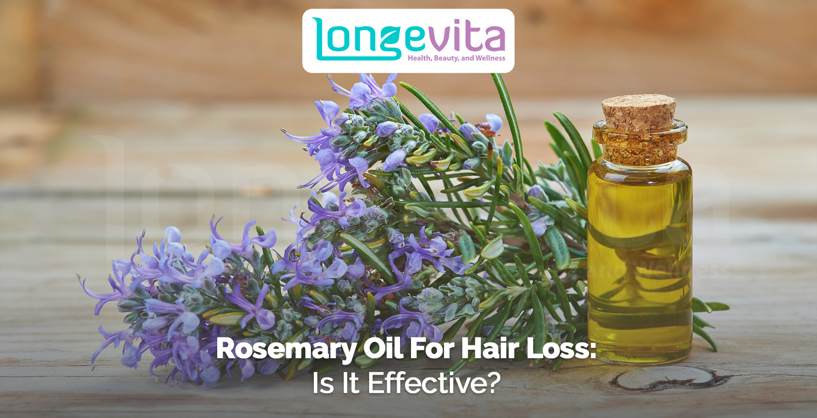 rosemary flowers and bottle of rosemary oil on wooden surface