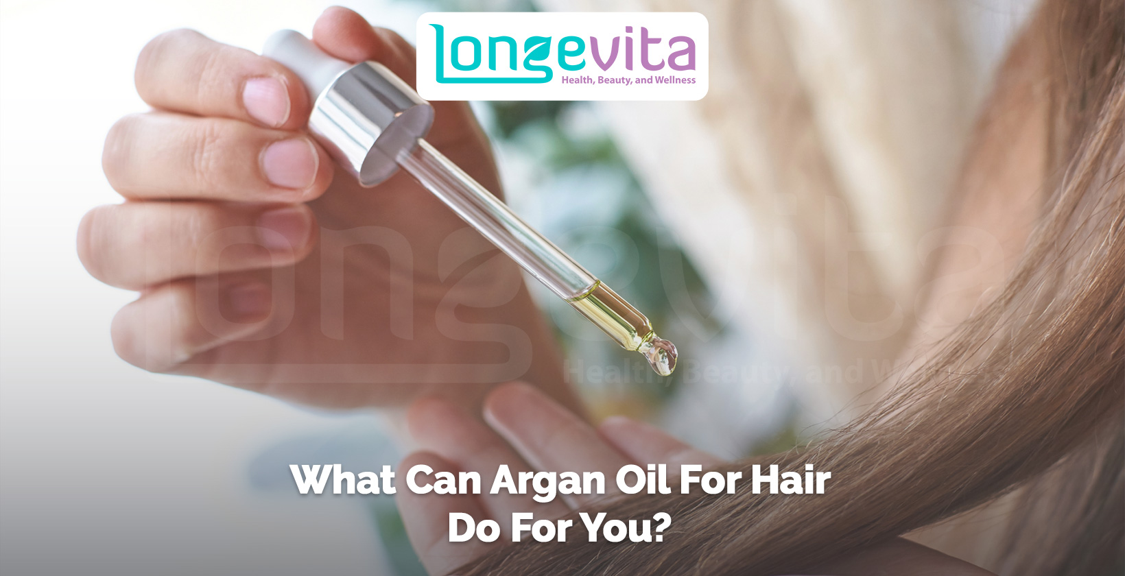 person applying argan oil to hair using a dropper