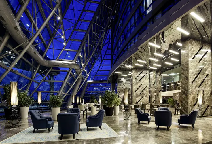 elegant and modern lobby interior of Pullman Istanbul Airport Hotel with seating and large glass windows